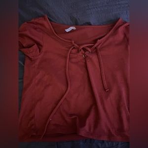 Orange-reddish t shirt with tie in the front. Very soft material. Hardly worn